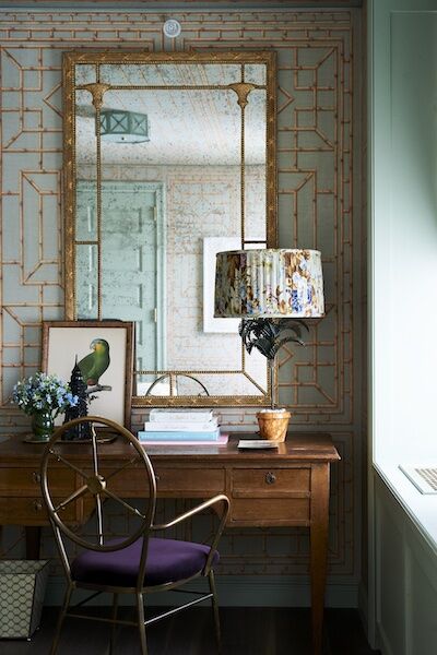 Photo of a room with a lamp and picture of a parrott