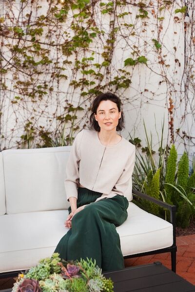 Woman sitting on a sofa outdoors